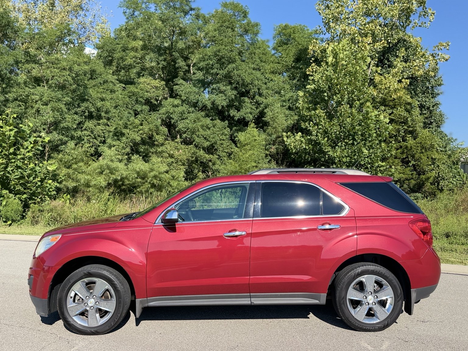 Driver side view of the red 2013 Chevrolet Equinox